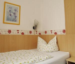 a bedroom with a bed with two pillows on it at Hotel Goldenes Faß in Würzburg