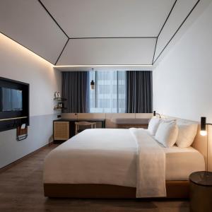 Postel nebo postele na pokoji v ubytování GAIA Cosmo Hotel