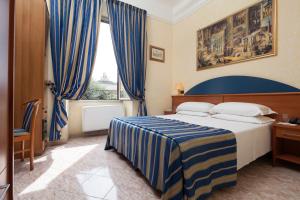 Postel nebo postele na pokoji v ubytování Hotel Kennedy