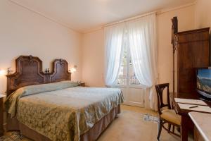Postel nebo postele na pokoji v ubytování Hotel Gardenia al Lago