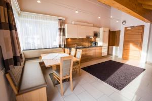 a kitchen with a table and a dining room at Appart's Platzl in Serfaus