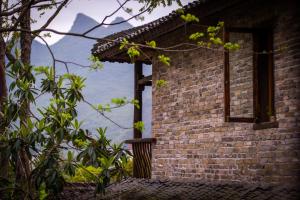 a brick building with a window on the side of it at Rural House in Yangshuo