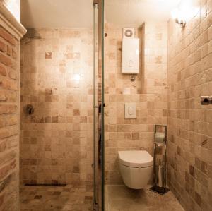 a bathroom with a toilet and a shower at Hotel Azimut in Sveti Stefan