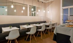 a dining room with white tables and white chairs at Hostal Central Barcelona in Barcelona
