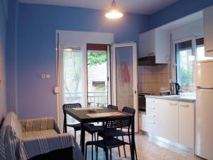 a kitchen with a table and chairs in a room at Sophies Apartments Ormos in Ormos Panagias +22 photos