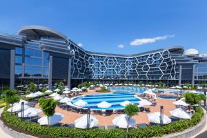 a resort with a pool and umbrellas and a building at Bosphorus Sorgun Hotel - Ultra All Inclusive in Side