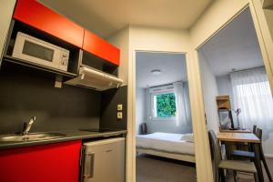 Kuchyň nebo kuchyňský kout v ubytování KOSY Appart'hôtel Le Champ De Mars Reims