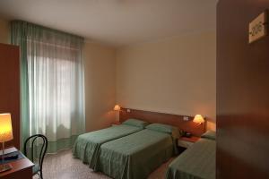 Postel nebo postele na pokoji v ubytování Mio Hotel Firenze