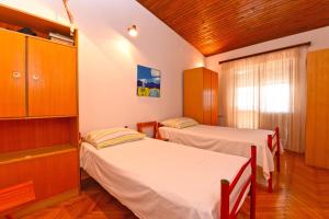 Postel nebo postele na pokoji v ubytování Apartment Milena 1560
