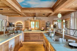 a large kitchen with wooden ceilings and wooden counters at Landhotel Augustin in Bad Staffelstein