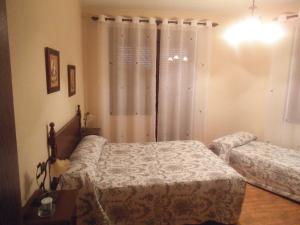 Posteľ alebo postele v izbe v ubytovaní Hostal Los Galgos