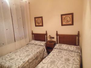Posteľ alebo postele v izbe v ubytovaní Hostal Los Galgos