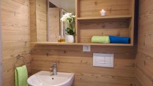 a bathroom with a sink and a mirror at New Camping Le Tamerici in Marina di Cecina +32 photos