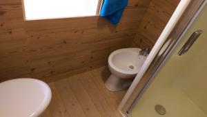 a bathroom with a toilet and a sink at New Camping Le Tamerici in Marina di Cecina