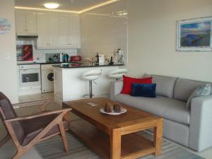 a living room with a couch and a table at WATERFRONT 15 QUAY WEST in Knysna
