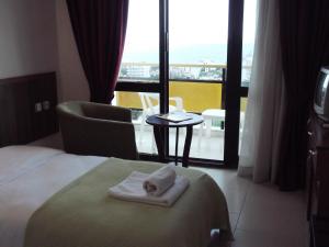 a hotel room with a bed and a view of a balcony at West Ada Hotel&SPA in Kuşadası