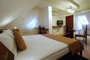 a bedroom with a large white bed with a window at Casa iRMA - Rooms for rent in Bacău