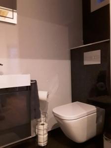 a bathroom with a white toilet and a sink at Byers Guest house in Banavie +22 photos