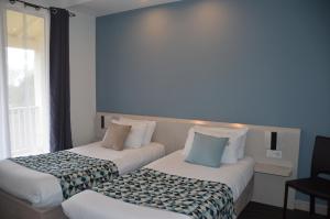Hotel et Spa Les Cleunes Oléron客房内的一张或多张床位