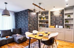 a living room with a couch and a table at Stylish and High-end Designer Apartments in City Center in Sofia +13 photos