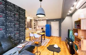 a living room with a couch and a table at Stylish and High-end Designer Apartments in City Center in Sofia