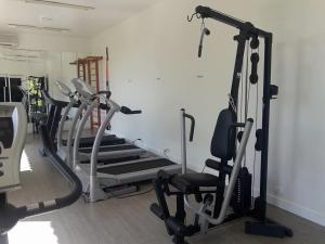 a gym with several treadmills and cardio machines at Camboa Hotel Paranaguá in Paranaguá