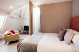 a bedroom with a large bed and a chair at Beech House in Bristol