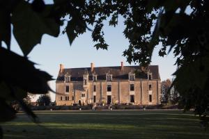 an image of a large castle with a grass field at Château de la Verie in Challans