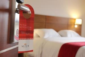 
a hotel room with a red blanket on the bed at Neper Hotel in Córdoba
