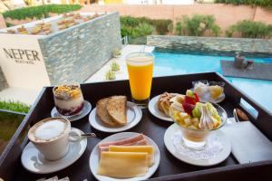 a tray of breakfast foods and drinks on a table at Neper Hotel in Córdoba