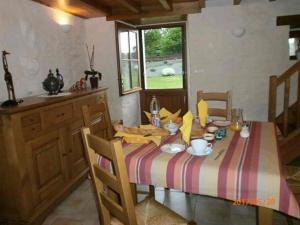 a dining room with a table with a plate of food on it at Chambre d'hotes Ty Braz 19 Tilibrennou 29690 BERRIEN in Berrien