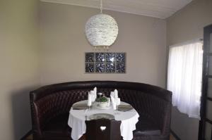 a dining room table with a white table cloth on it at Mariental Hotel Cc in Mariental