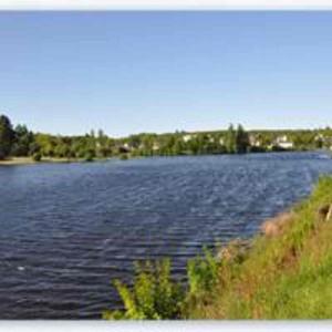 a large body of water with trees in the background at Chambre d'hotes Ty Braz 19 Tilibrennou 29690 BERRIEN in Berrien