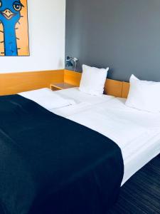 Postelja oz. postelje v sobi nastanitve Hotel Garni