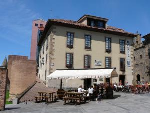 people sitting at tables outside of a building at La Casona de Jovellanos in Gijón