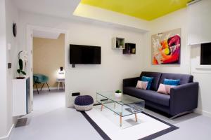 a living room with a couch and a glass table at Bilbao Centric Apartments in Bilbao