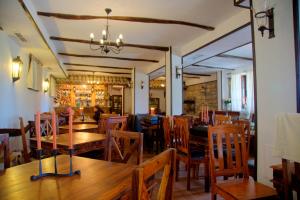 a dining room with wooden tables and chairs at Villa Bulgara Eco in Madara