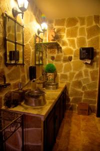 a stone bathroom with two sinks and a stone wall at Villa Bulgara Eco in Madara