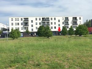 a large white building with a field in front of it at Münster City Apartment in Münster