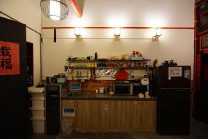 a kitchen with a sink and a counter top at Beishan Old Western Style Hostel in Jinning