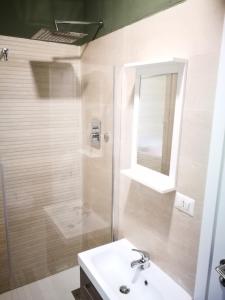 a bathroom with a shower and a sink and a mirror at La Caravella apartament in Rapallo