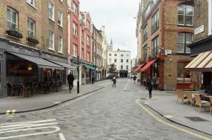 a city street with people walking down the street at Veeve - Marylebone Mews in London