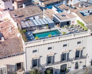 an aerial view of a white building with a swimming pool at Sant Francesc Hotel Singular in Palma de Mallorca