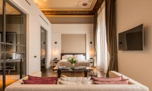 a living room with a bed and a couch at Sant Francesc Hotel Singular in Palma de Mallorca