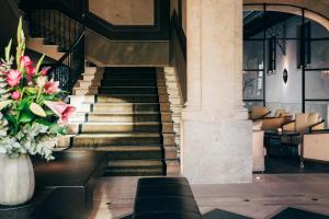 a staircase in a building with a vase of flowers at Sant Francesc Hotel Singular in Palma de Mallorca