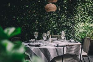 a table with a white table cloth and wine glasses at Sant Francesc Hotel Singular in Palma de Mallorca