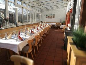 a long dining room with tables and chairs at Spessarter Hof in Hobbach