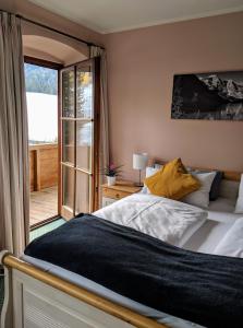 a bedroom with a large bed and a balcony at Chalet Sonneck in Seefeld in Tirol