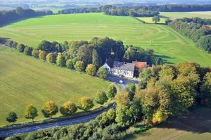 an aerial view of a house in the middle of a field at Hotel Marienhof Baumberge in Nottuln