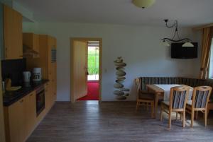 a kitchen and dining room with a table and chairs at Appartement Tauernhof in Kleinarl